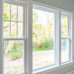 Livingroom, one center picture window with a single hung window on each end.