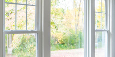 Livingroom, one center picture window with a single hung window on each end.